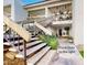 Exterior shot of the property, featuring stairs leading to upper units and a glimpse of the front door at 3002 N 70Th St # 120, Scottsdale, AZ 85251