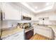 Beautiful kitchen featuring granite countertops, stainless steel appliances, and white cabinetry at 3002 N 70Th St # 120, Scottsdale, AZ 85251