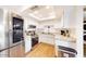 Modern kitchen with white cabinets, stainless steel appliances, and granite countertops at 3002 N 70Th St # 120, Scottsdale, AZ 85251