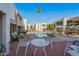 Community pool area with a hot tub, lounge chairs, and various seating areas under a clear sky at 3002 N 70Th St # 120, Scottsdale, AZ 85251
