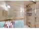Modern shower featuring beige marble-look tile, a glass door, and a rainfall shower head at 3002 N 70Th St # 120, Scottsdale, AZ 85251
