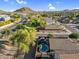 Aerial view of a suburban neighborhood with houses and roads nestled amongst mountains at 32881 N Hidden Canyon Dr, San Tan Valley, AZ 85144