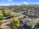 Expansive aerial view of a quiet neighborhood with lush trees and mountain views in the distance, under a clear blue sky at 32881 N Hidden Canyon Dr, San Tan Valley, AZ 85144