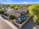 Aerial view showing the backyard oasis with pool, gazebo, lush landscaping and solar panels on the roof at 32881 N Hidden Canyon Dr, San Tan Valley, AZ 85144
