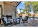A covered patio with nice outdoor seating area with view of pool and well-maintained yard at 32881 N Hidden Canyon Dr, San Tan Valley, AZ 85144