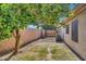 Wide open backyard showing gravel landscaping and air conditioner unit and gate at 32881 N Hidden Canyon Dr, San Tan Valley, AZ 85144