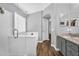 Bright bathroom featuring wood-look floors, neutral paint, and a glass-enclosed shower at 32881 N Hidden Canyon Dr, San Tan Valley, AZ 85144