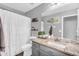 Bright bathroom featuring a granite countertop, modern fixtures, and shower with curtain at 32881 N Hidden Canyon Dr, San Tan Valley, AZ 85144