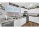 Bright kitchen featuring granite countertops and a stainless steel dishwasher under the large window at 32881 N Hidden Canyon Dr, San Tan Valley, AZ 85144