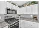 Close up of kitchen with stainless steel oven/stove with microwave and granite countertops at 32881 N Hidden Canyon Dr, San Tan Valley, AZ 85144