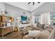 Bright living room features a large sofa, stylish decor, and a big window for natural light at 32881 N Hidden Canyon Dr, San Tan Valley, AZ 85144