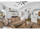 Spacious living room boasts modern decor, an inviting sofa, and flows into dining area at 32881 N Hidden Canyon Dr, San Tan Valley, AZ 85144