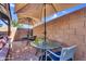 Cozy patio with brick flooring, outdoor seating, and shaded by umbrellas at 32881 N Hidden Canyon Dr, San Tan Valley, AZ 85144
