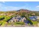 Panoramic aerial view showcases a sprawling home with mature landscaping and a mountain backdrop at 3981 E Runaway Bay Pl, Queen Creek, AZ 85142