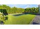 This backyard showcases a spacious lawn with in-ground trampolines surrounded by mature trees at 3981 E Runaway Bay Pl, Queen Creek, AZ 85142