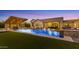 Scenic backyard featuring a pool with lounge chairs, outdoor kitchen and modern design at 3981 E Runaway Bay Pl, Queen Creek, AZ 85142