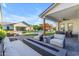 This backyard boasts a covered patio, a modern outdoor fire pit, a swimming pool and luscious landscaping at 3981 E Runaway Bay Pl, Queen Creek, AZ 85142