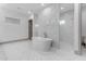 Stylish bathroom featuring a standalone tub and large walk-in shower with white marble tiling at 3981 E Runaway Bay Pl, Queen Creek, AZ 85142