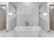 Luxurious bathroom featuring a freestanding tub, dual shower, and elegant marble floors at 3981 E Runaway Bay Pl, Queen Creek, AZ 85142