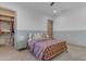 Comfortable bedroom featuring a cozy bed with a light purple comforter, bedside table and access to a closet at 3981 E Runaway Bay Pl, Queen Creek, AZ 85142