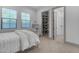 A cozy bedroom with ample natural light, carpet floors, access to a walk-in closet and attached bathroom at 3981 E Runaway Bay Pl, Queen Creek, AZ 85142