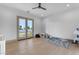 Spacious room featuring wood flooring, an overhead fan, and double doors leading to an outside living area at 3981 E Runaway Bay Pl, Queen Creek, AZ 85142