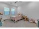 A bright bedroom with carpet floors and a comfortable bed illuminated by natural light from two large windows at 3981 E Runaway Bay Pl, Queen Creek, AZ 85142