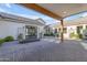 Beautiful courtyard featuring brick pavers, white exterior walls and a modern outdoor fireplace feature at 3981 E Runaway Bay Pl, Queen Creek, AZ 85142