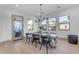 A dining table with seating for six, set in front of a trio of windows and a doorway at 3981 E Runaway Bay Pl, Queen Creek, AZ 85142