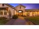 Inviting walkway towards a charming brick archway and front courtyard leading to the warm-lit home interior at 3981 E Runaway Bay Pl, Queen Creek, AZ 85142