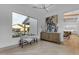 Bright entryway with wood floors, neutral walls, stylish bench, and window views of the spacious backyard and pool at 3981 E Runaway Bay Pl, Queen Creek, AZ 85142