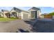 Beautifully landscaped exterior with a spacious driveway, attached garage, and manicured lawn at 3981 E Runaway Bay Pl, Queen Creek, AZ 85142