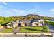 An expansive home featuring manicured landscaping and impressive stone and timber accents at 3981 E Runaway Bay Pl, Queen Creek, AZ 85142