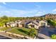 Beautiful home showcasing lush landscaping, a charming entrance, and a spacious three-car garage at 3981 E Runaway Bay Pl, Queen Creek, AZ 85142