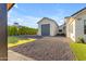 Beautiful exterior with spacious driveway, gravel yard, detached garage, and lush greenery at 3981 E Runaway Bay Pl, Queen Creek, AZ 85142