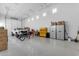 Spacious garage with epoxy floors, storage cabinets, and a white GMC truck parked inside at 3981 E Runaway Bay Pl, Queen Creek, AZ 85142