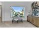 Hallway showcasing herringbone wood floors, a view to the outdoor patio, and an elegant wooden console table at 3981 E Runaway Bay Pl, Queen Creek, AZ 85142