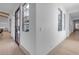 Hallway featuring hardwood floors, natural light from windows, and decorative doors showcasing modern architecture at 3981 E Runaway Bay Pl, Queen Creek, AZ 85142