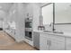 Modern kitchen with stainless steel appliances, white cabinets, and hardwood flooring at 3981 E Runaway Bay Pl, Queen Creek, AZ 85142