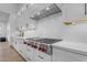 Modern kitchen features white cabinetry and a stainless steel Wolf range at 3981 E Runaway Bay Pl, Queen Creek, AZ 85142