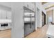 Modern kitchen with stainless steel appliances, white cabinets, and hardwood flooring at 3981 E Runaway Bay Pl, Queen Creek, AZ 85142