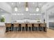 Bright, modern kitchen with a large island, pendant lighting, white cabinets, and comfortable seating for six at 3981 E Runaway Bay Pl, Queen Creek, AZ 85142