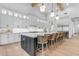 Stunning modern kitchen with a large island, white cabinets, long breakfast bar and great natural light at 3981 E Runaway Bay Pl, Queen Creek, AZ 85142