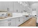 Contemporary kitchen with white cabinetry, hardwood floors, and stainless steel appliances at 3981 E Runaway Bay Pl, Queen Creek, AZ 85142