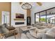 Comfortable living room showcasing modern fireplace, brick accent wall, and large glass sliding door to exterior space at 3981 E Runaway Bay Pl, Queen Creek, AZ 85142