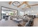 Bright, open concept living room featuring high ceilings, wood beams, seamless indoor/outdoor living, with view into kitchen at 3981 E Runaway Bay Pl, Queen Creek, AZ 85142