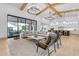 Spacious living room with modern furnishings, high ceilings with wood beams, and a large sliding glass door to the backyard at 3981 E Runaway Bay Pl, Queen Creek, AZ 85142