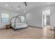 Main bedroom featuring a canopy bed, neutral decor, and wood floors for a serene and inviting space at 3981 E Runaway Bay Pl, Queen Creek, AZ 85142
