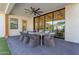 Covered outdoor patio with a dining table set, ceiling fan, and views of the backyard at 3981 E Runaway Bay Pl, Queen Creek, AZ 85142