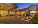 Elegant outdoor patio with water feature, fire pit, covered area and seamless indoor-outdoor living at 3981 E Runaway Bay Pl, Queen Creek, AZ 85142